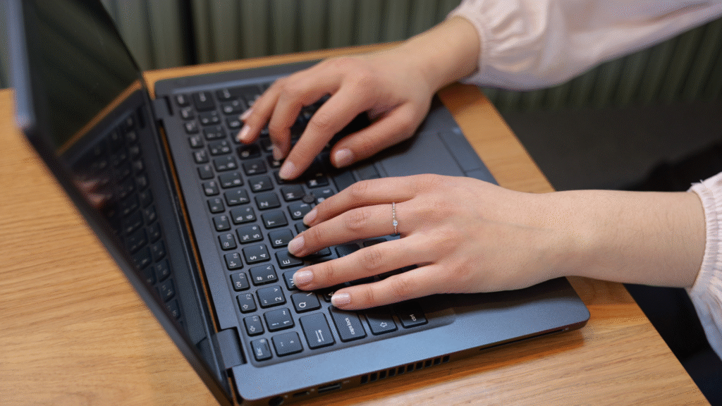hands on a laptop, coding a website
